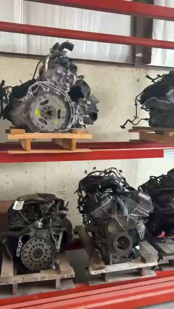 A used engine on a wooden pallet, seen up close
